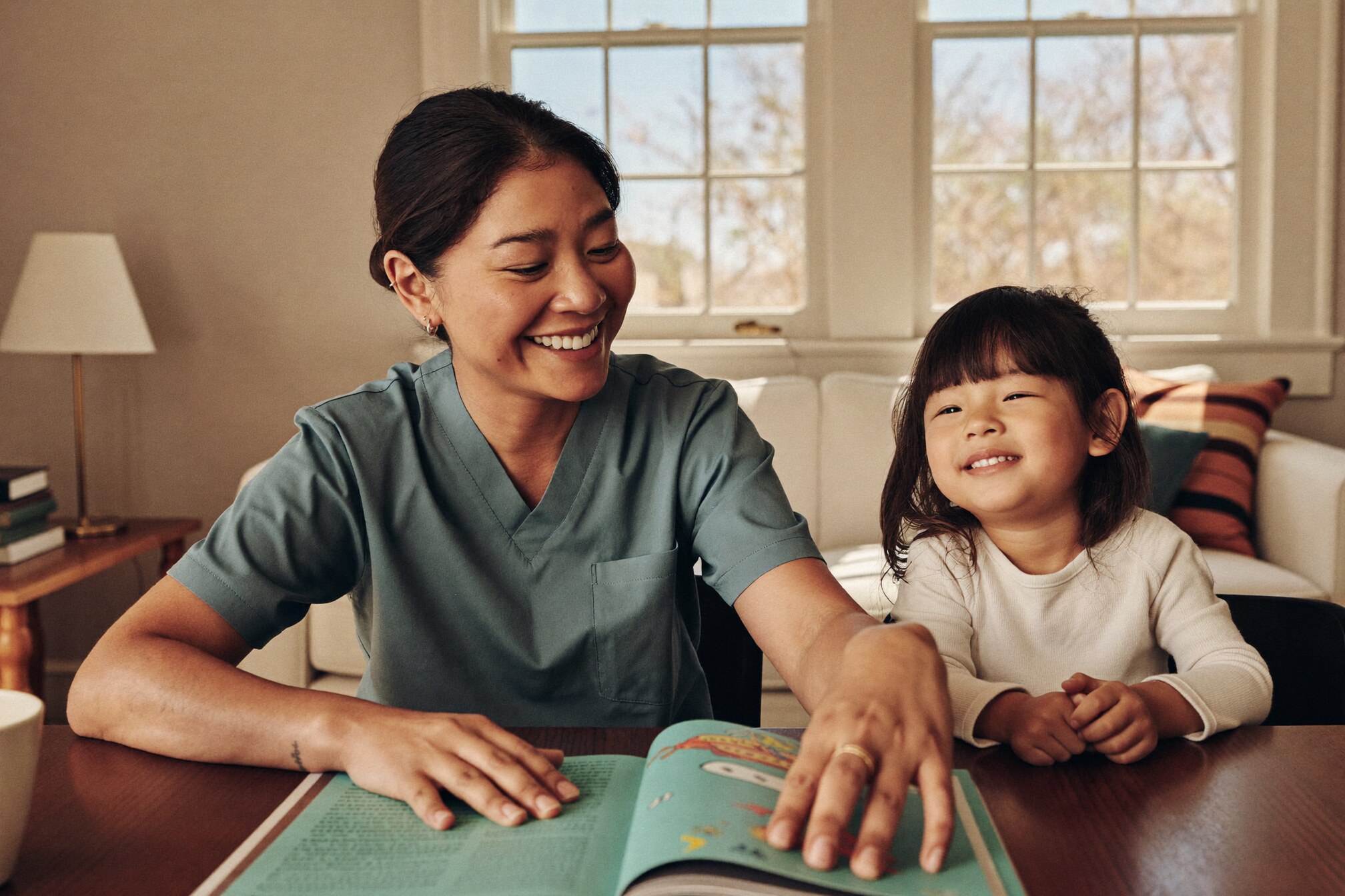A parent and young child at home together.